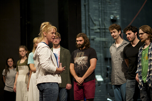 Guest Director Melora Kordos (front) visits with her cast during a rehearsal for "Love's Labor's Lost," which opens Nov. 13.