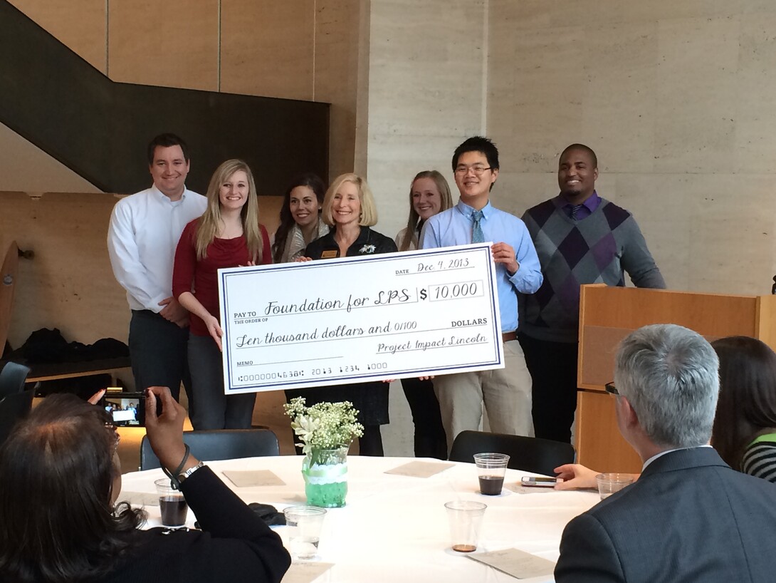 Members of the Leading People and Projects class in the College of Business Administration award a grant of $10,000 to the LPS "Hear to Learn" project.  