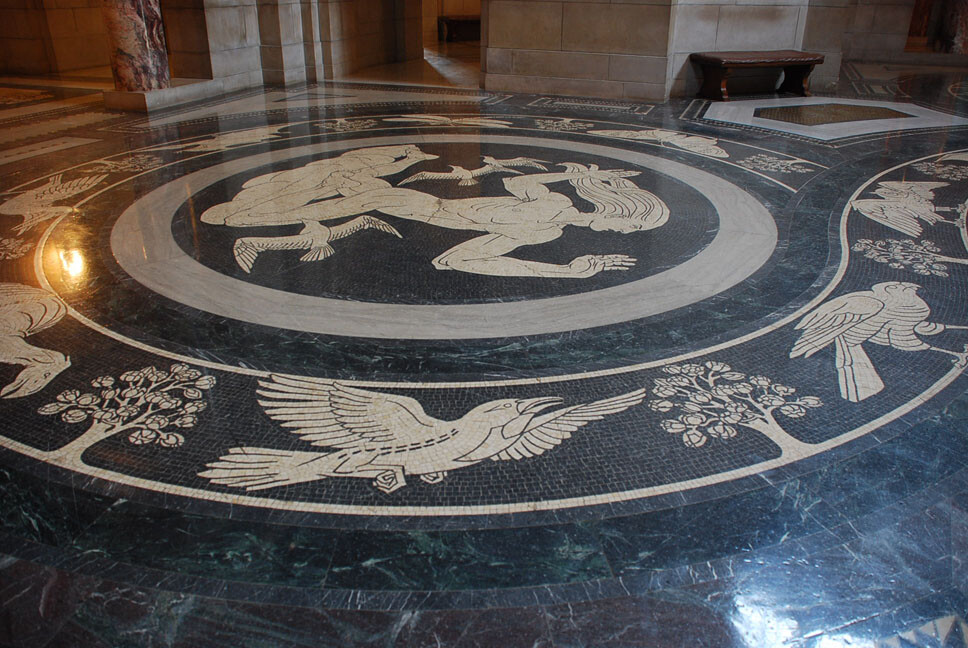 The Rotunda floor features bands around the main medallions, which contain images or prehistoric life found in Nebraska. 