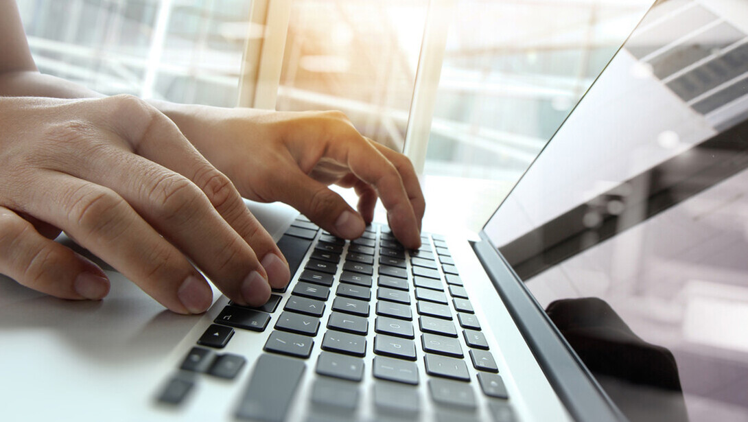 hands type on a keyboard