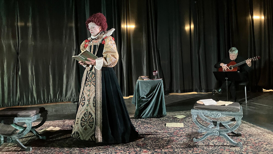 An actress is in full monarchy regalia as Queen Elizabeth I. 