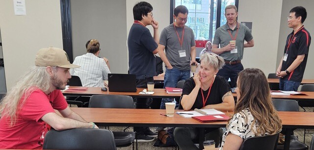 Entrepreneurship workshop participants smile during a discussion.