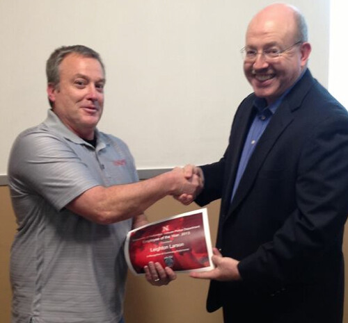 Chief Owen Yardley (right) congratulates Community Service Officer Leighton Larson, who was named UNLPD's Employee of the Year.