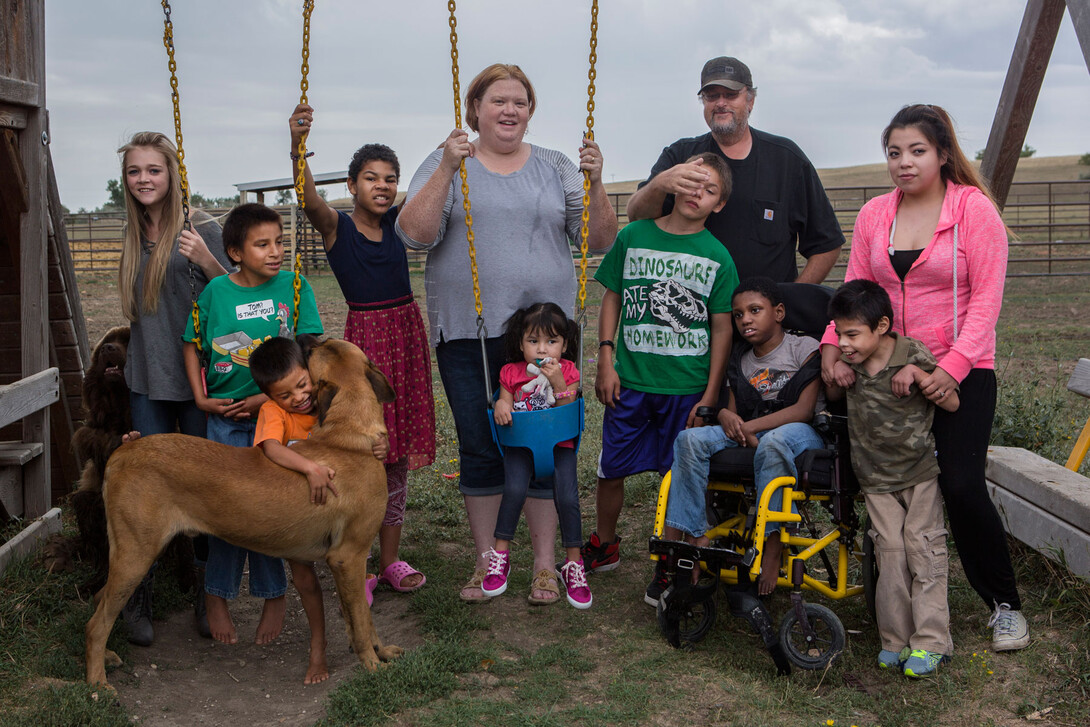 Nora and Randy Boesem have adopted 12 children suffering from fetal alcohol spectrum disorder. Since 2001, the Boesems have taken in more than 100 foster children. Boesem family members pictured are (from left) Rachel (15), Jeremy (10), Mark (4), Frannie (12), Nora, Dontae (14), Randy, Kayleigh (10), A.J. (10), Michelle (15) and Arianna (5) in the middle. Not pictured is Vincent (24), the late baby Justice and the late Donovan.